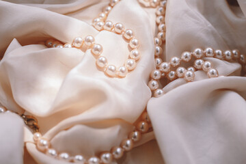 Pink pearls against a fabric