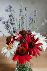 Fototapeta na wymiar Wildflower bouquet with lavender, echinacea, and daisies