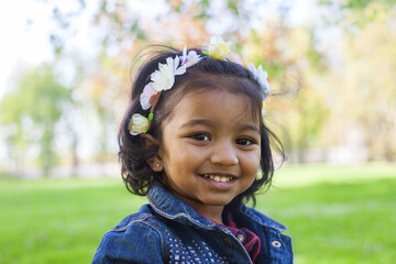 portrait of a little happy girl in spring park - 362235369