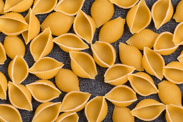 Pasta raw closeup background. Conchilioni close up. Cook background