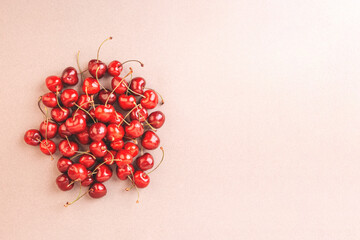 Cherry on a beige background. Copy space.