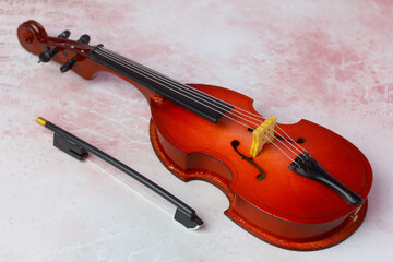 miniature toy contrabass with a bow  