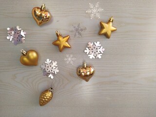 Gold-plated Christmas toys and tinsel on a light blue wooden background