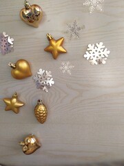 Gold-plated Christmas toys and tinsel on a light blue wooden background