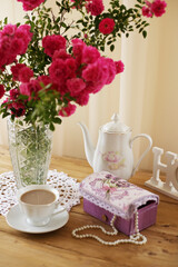 Fototapeta na wymiar summer morning with the scent of roses and tea with milk