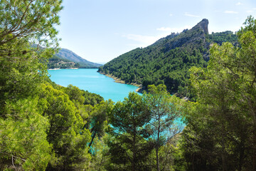 Dam reserevoir lake surrounded by green forest mountains at Guadalest, Costa Blanca, Spain