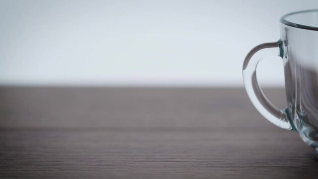 slowly pour kefir into a glass cup