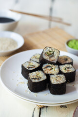 Sushi rolls with eel, sesame, cucumber and wasabi 