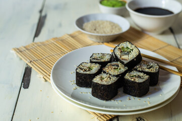Sushi rolls with eel, sesame, cucumber and wasabi 