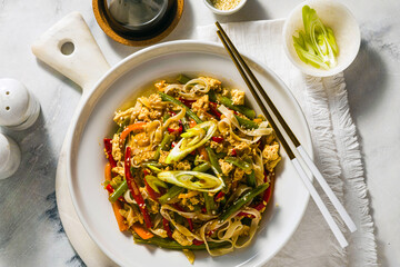 Thailand street food - Pad Thai with tofu in a plate on a table, in a restaurant or cafe