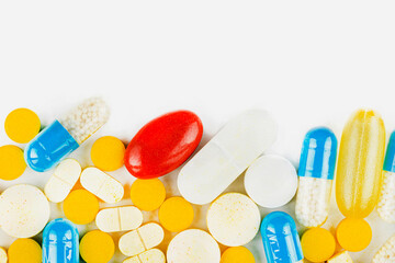 Background made of different kinds of colorful pills and tablets, macro shot, top view, space for text on top.