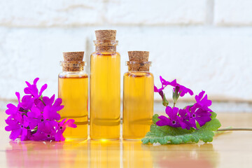Fototapeta na wymiar primrose essential oil in beautiful bottle on table