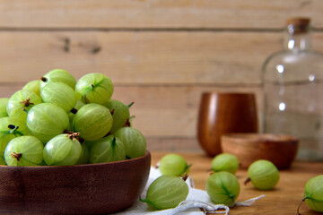Fresh organic Gooseberries in a wooden bowl