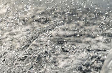 Splashing water in the rays of sunlight. Fun on the beach, background	