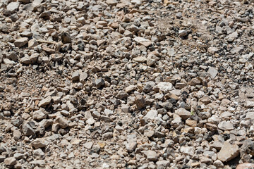 Close up of crushed rock, stone raw material for construction industry. Stones for use as background and texture.