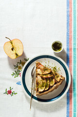 italian apple pie crostata with pistachio crumbs on the table with a white tablecloth