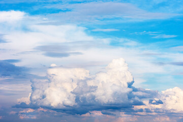 Beautiful pink, blue clouds and blue sky. Clouds reflect the sunset with a beautiful iridescence.