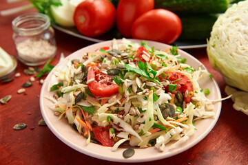 healthy food - fresh chopped vegetables on a wooden background, tomatoes and greens
