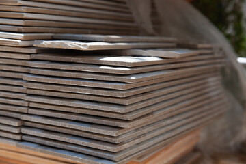 Ceramic tile stack on the floor. Preparation of tiles for construction. Pile of tiles prepared for...