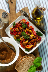 summer snacks of sweet peppers and sun-dried tomato cream with bread and spices on the table