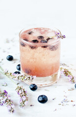 Cold carbonated lemonade (soda) with blueberries and lavender syrup. Soft focus. Place for text. Copy Space
