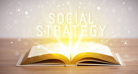 Open book with SOCIAL STRATEGY inscription, social media concept