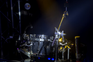 Obraz na płótnie Canvas Drums and drum set. Beautiful blue and red background, with rays of light. Beautiful special effects of smoke and lighting.