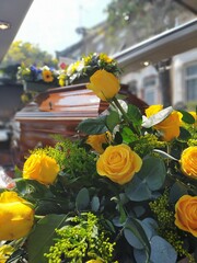yellow rose and casket in hearse , funeral 