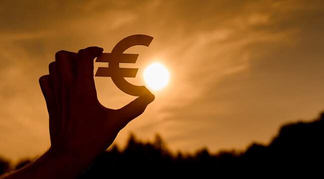 Euro symbol in women's hands contoured at sunset - Powered by Adobe