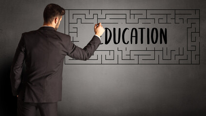 businessman drawing maze with EDUCATION inscription, business education concept