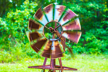 Old rusted windmill spinning around, slow shutter