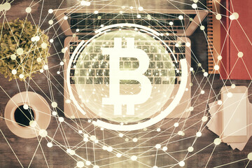 Blockchain theme hologram drawings over computer on the desktop background. Top view. Double exposure.