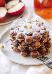 Gresh apple waffels with icing sugar and fresh apples breakfast, close up
