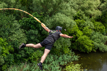 Ivanovsky Bridge, Ukraine - June 21, 2020: Concept of Extreme Sports and Fun. The man is  doing...