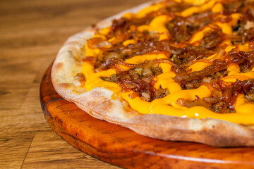 cheddar cheese, onion pizza and meat. on wooden background