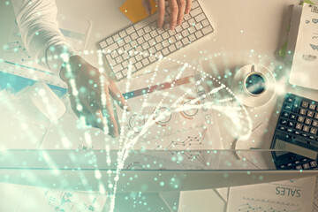 Double exposure of man's hands typing over computer keyboard and DNA hologram drawing. Top view. Medical education concept.