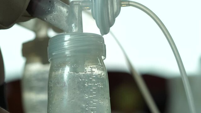 mother is using single electric breast milk pump and pumping breast milk for her baby. Breast milk for supplementary feeding, infant nutrition.