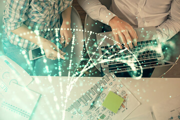 Double exposure of man and woman working together and DNA hologram drawing. Computer background. Medical education concept. Top View.