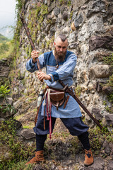 Viking warrior brandishes an ax in a threatening way