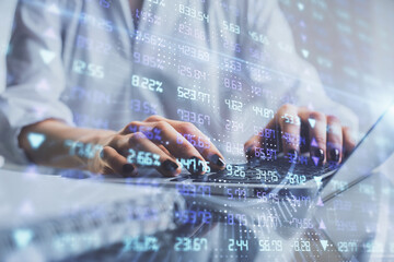 Double exposure of woman hands typing on computer and forex chart hologram drawing. Stock market invest concept.