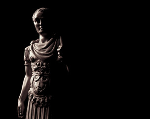 Sculpture of Julius Caesar on black background - obrazy, fototapety, plakaty