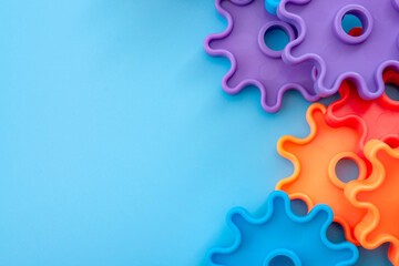 Teamwork and solidarity concept with photograph of connected colorful plastic toy gears with each...