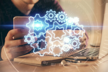 Double exposure of man's hands holding and using a phone and international business theme drawing.