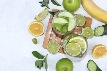 Vegetables, fruits, juice and smoothies on a light background flat lay. The concept of healthy and natural food for weight loss, lifestyle, detox diet, 