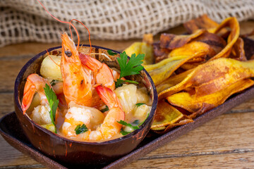 Shrimp with Thai pineapple and banana chips. top view