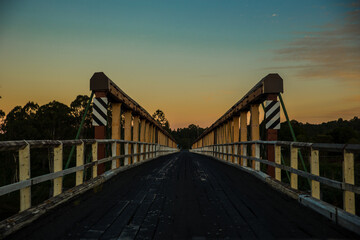 Classic bridge during sunset middle of the road