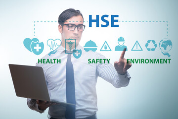 HSE concept with businessman pressing virtual button