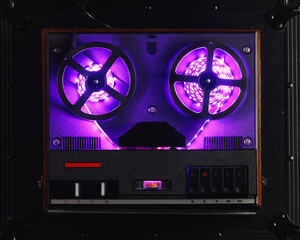 reel to reel audio tape recorder with purple led light strip. VU meter with 