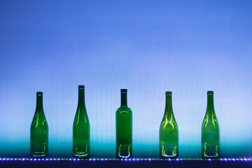 abstract empty wine bottles with blue led illumination