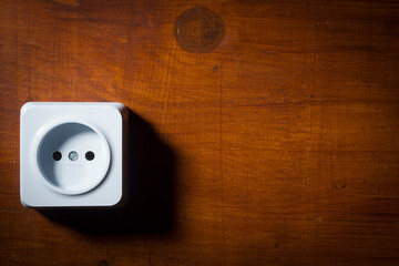 Electrical outlet on wooden wall